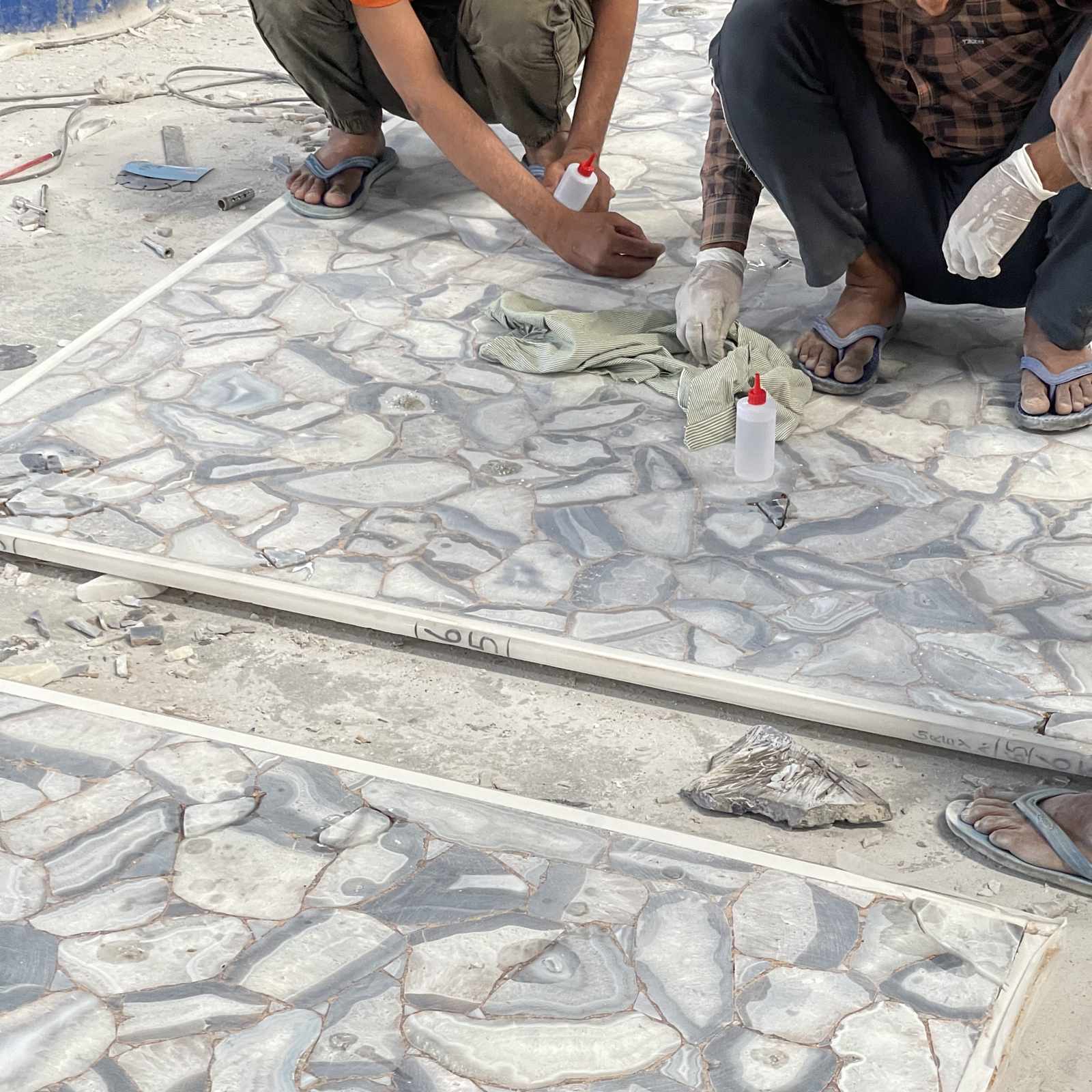 Engineered semi-precious surface being laid by hand